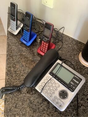 3 portable Phones plus 1 Silver Corded Desk Phone with Answering Machine